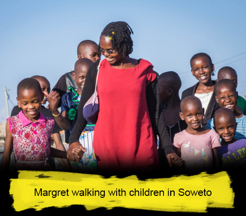 Margret walking with children in Soweto